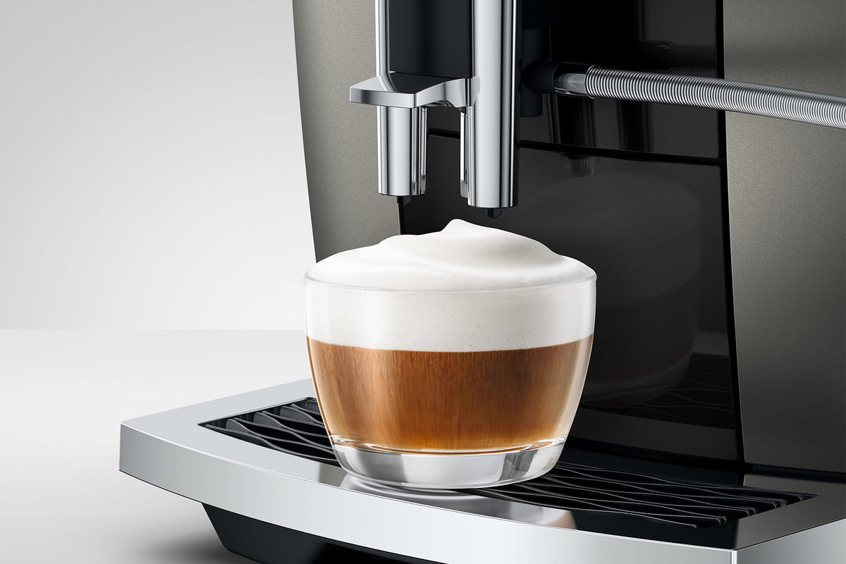 Cappuccino under the JURA E6 milk spout