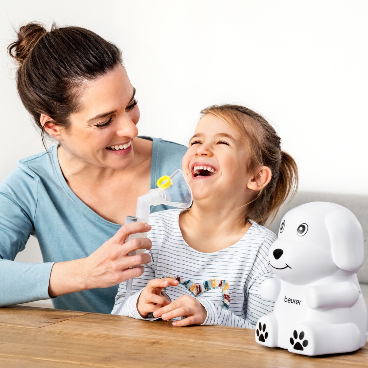 Mother and daughter laughing with a Beurer children's nebuliser