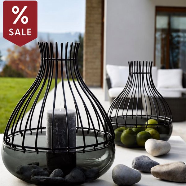 Blomus wire lanterns on a patio table with a sale tag