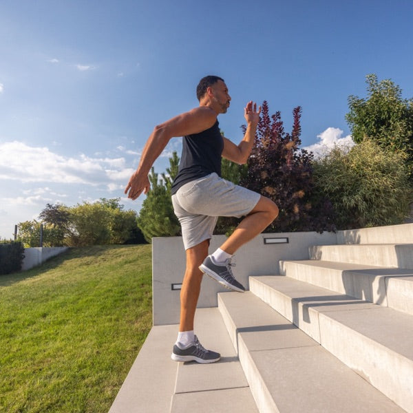 Man running up outdoor steps in the sun